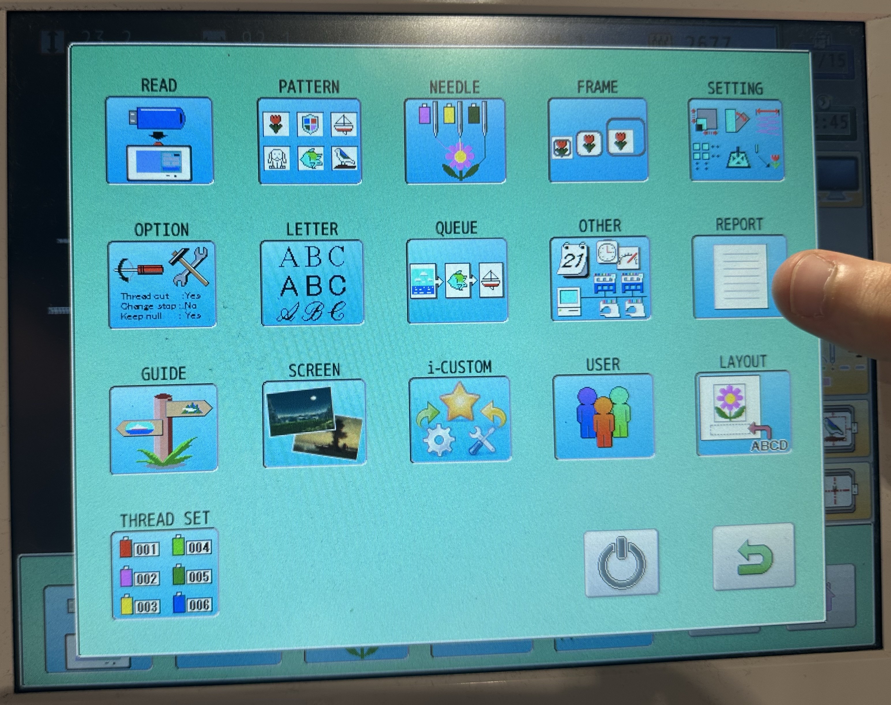 The HCR3's native touchscreen home menu, a 4x5 grid of icon buttons: Read, Pattern, Needle, Frame, Setting, Option, Letter, Queue, Other, Report, Guide, Screen, i-Custom, User, Layout, Thread Set